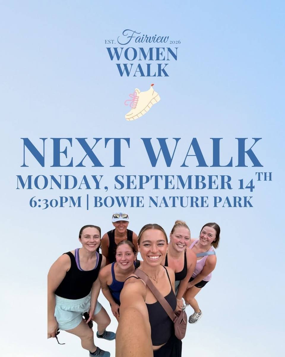 A group of six smiling women pose together outdoors before their evening walk.