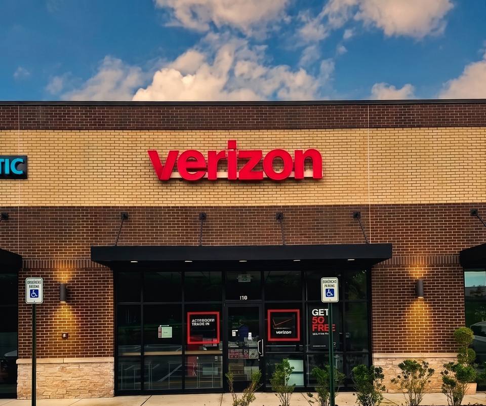 The new Verizon storefront on Fairview Boulevard, red lettering above a glass entrance in a brick retail building